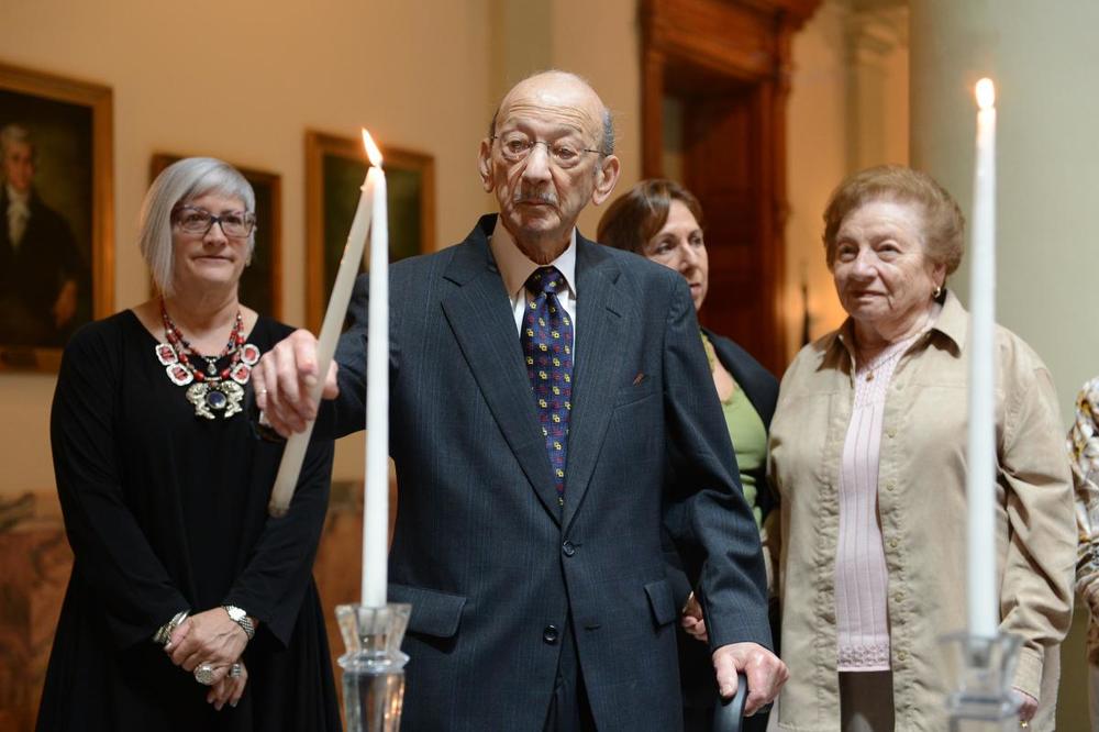 Holocaust survivor John Silva lights a candle at the 2013 Days of Remembrance ceremony.