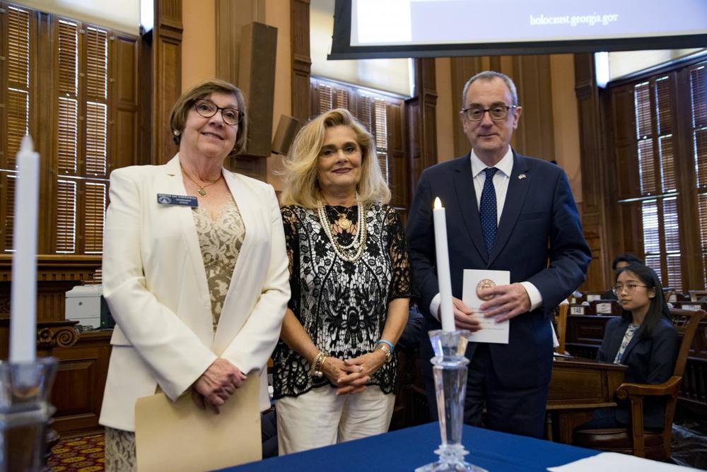Mariella Crea lights a candle in memory of her mother, Jacqueline Garascia, who was a rescuer in France