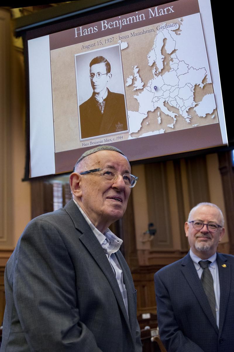 Holocaust survivor Hans Benjamin Marx lights a candle at the 2019 Days of Remembrance ceremony.