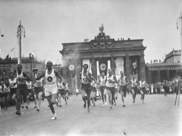 Berlin, Germany - Aug. 1, 1936: A German runs with the Olympic torch, inaugurating a new Olympic ritual where the torch is relayed from Olympia, Greece. Photo: National Archives and Records Administration, College Park, Md.