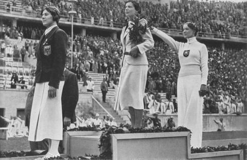 Berlin, Germany - Aug. 14, 1936 - Helene Mayer (far right) of Germany receives the silver medal in women's fencing. Photo: Library of Congress.
