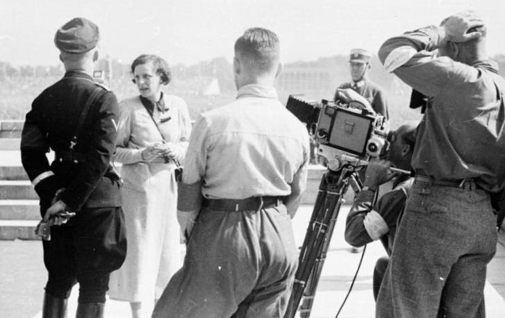 Nuremberg, Germany - Sep. 9, 1934: Leni Riefenstahl (center) with Heinrich Himmler (left), Reich Leader of the SS, while filming scenes for "Triumph of the Will" at Luitpold Arena. Photo: German Federal Archives.